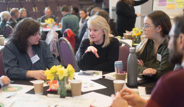People chatting together at Doughnut Economics workshop 1 March 2024. Photograph by Alice Lousia.